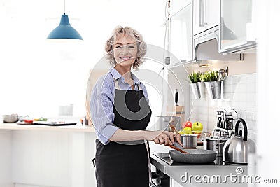 Professional female chef cooking vegetables Stock Photo