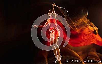 Professional female tennis player isolated on black studio background in mixed light Stock Photo