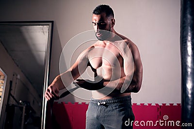 Professional fighter preparing for training, wraping his hands a Stock Photo