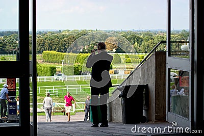 A gambler with binoculars at the races. Editorial Stock Photo