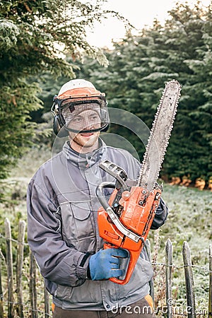 Professional gardener with chainsaw Stock Photo