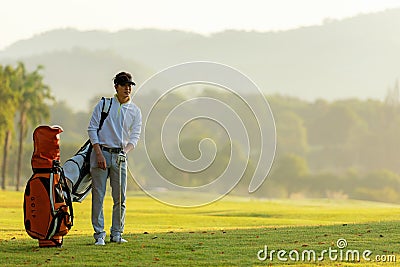 Professional Golfer asian man walking in fairway with bag golf with club. Hobby in holiday and vacation with friends. Stock Photo