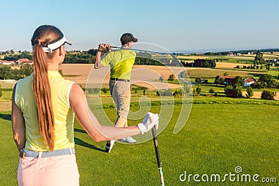Professional golfer standing in the finish position of long drive shot Stock Photo