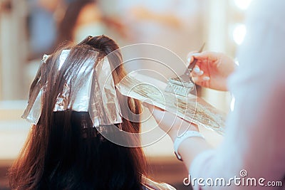 Professional Hair Colorist Dying a Piece of Hair in a Salon Stock Photo