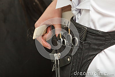 Professional hairdresser tools in belt Stock Photo