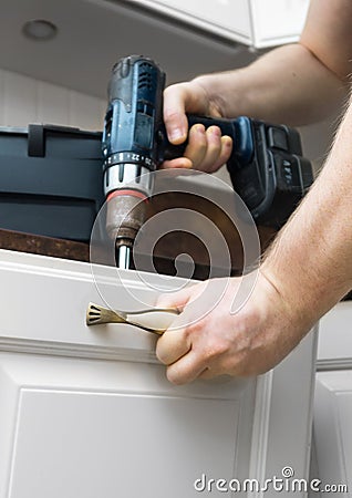 Professional handyman assembling cabinet Stock Photo