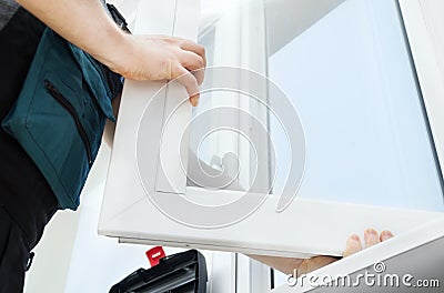 Professional handyman installing window Stock Photo