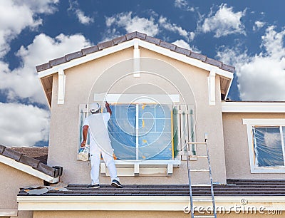 Professional House Painter Painting the Trim And Shutters of A H Stock Photo