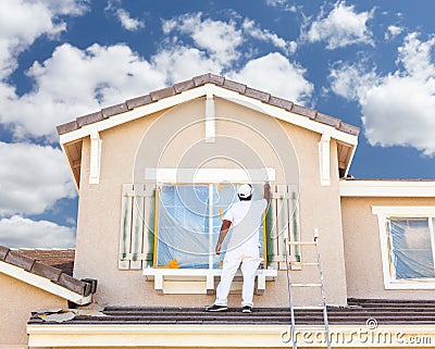 Professional House Painter Painting the Trim And Shutters of A H Stock Photo