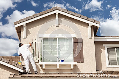 Professional House Painter Painting the Trim And Shutters of A H Stock Photo