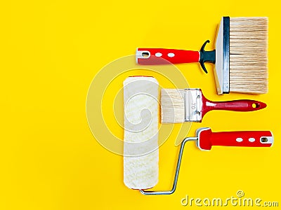 Professional house painter, work tools on yellow background Stock Photo