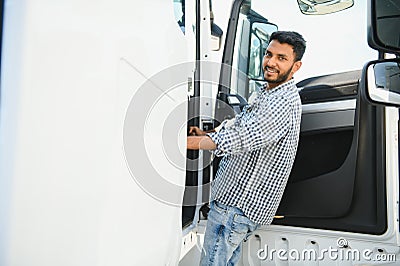 Professional indian truck driver entering his truck long vehicle. Loving his job. Transportation services. Stock Photo