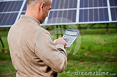 Professional investor calculating his possible profit from alternative enegry sources. Stock Photo