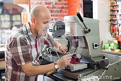 Professional key cutter making door keys copies Stock Photo