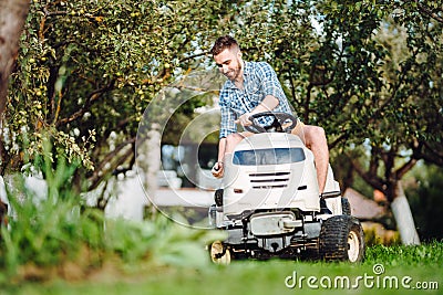 Professional landscaper using tractor at mowing lawn Stock Photo