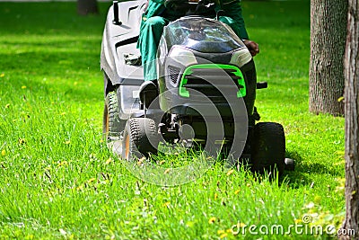 Professional lawn mower grass cutting in a park. Stock Photo