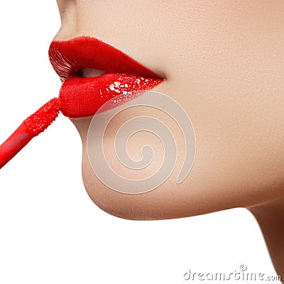 Professional lips make-up. Lipgloss and brush. Lipstick. Beauty girl applying lip gloss. lips. Beauty red lip makeup detail Stock Photo