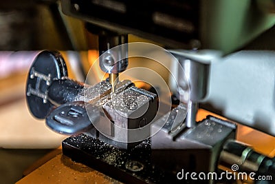Locksmith key duplicate machine makes new key Stock Photo