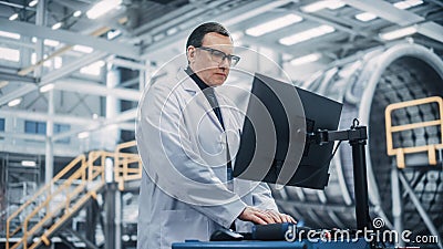 Professional Male Heavy Industry Engineer/Worker Working on a Computer. Confident Caucasian Stock Photo