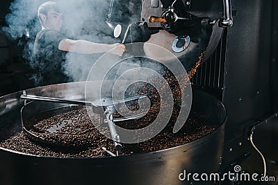 Professional male roaster loading machine Stock Photo