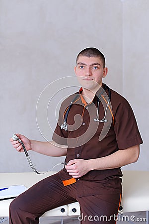 Professional male therapist looks at camera with smile and sitti Stock Photo