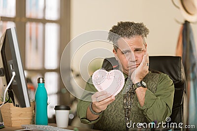 Professional Man Reacting Negatively to Valentine Stock Photo