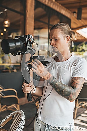 Professional man videographer with gimball video slr Stock Photo