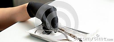 Professional manicure master prepares nail care tools on a white background with copy space. Stock Photo