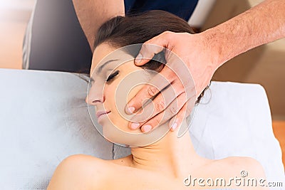 Professional massage at the neck of a woman Stock Photo