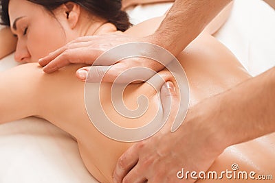 Professional masseur making intensive massage Stock Photo