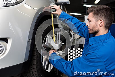 Professional mechanic adjusting automobile wheel alignment Stock Photo