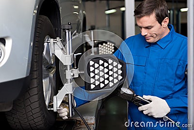 Professional mechanic chacking cars wheel system Stock Photo