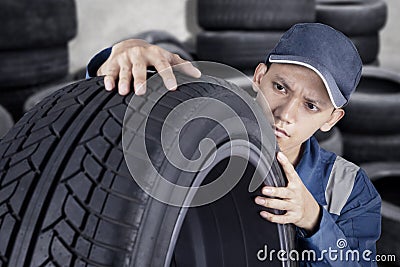 Professional mechanic checking tyre Stock Photo