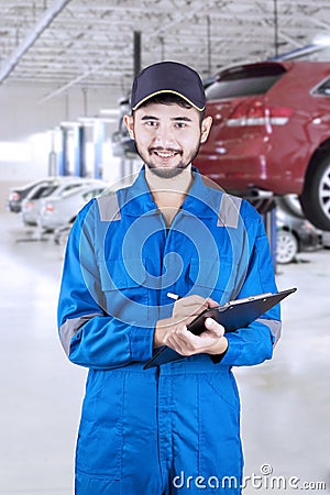 Professional mechanic holding clipboard Stock Photo