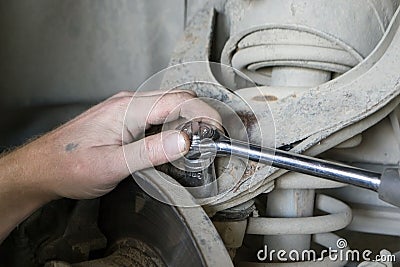 A professional mechanic repairs the car. Stock Photo