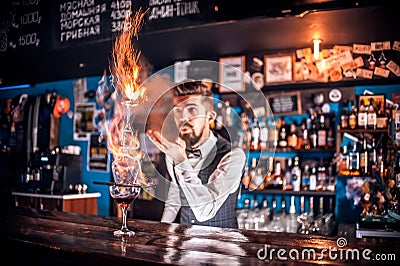 Professional mixologist decorates colorful concoction at the nightclub Stock Photo