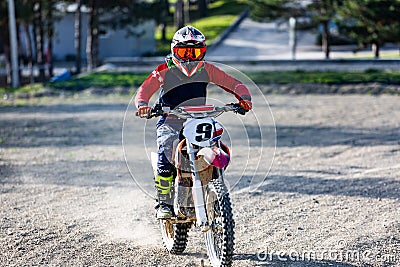 Professional Motocross Motorcycle Rider Drives Over the Road Track. Stock Photo