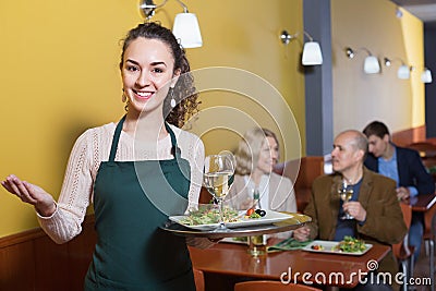 Professional nippy with tray posing at table Stock Photo