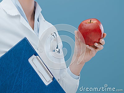 Professional nutritionist holding an apple Stock Photo