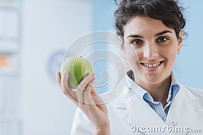 Professional nutritionist holding a fresh apple Stock Photo