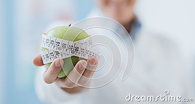 Professional nutritionist holding a fresh apple Stock Photo