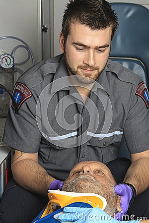 Professional paramedics giving unconscious men Stock Photo