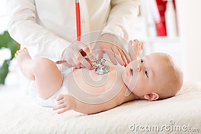 Professional pediatrician examining infant baby Stock Photo