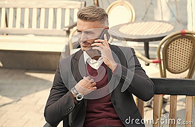 Professional person in formal style talk on modern phone mobile device resting in outdoor cafe, smartphone Stock Photo