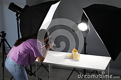 Professional photographer shooting stylish shoes Stock Photo