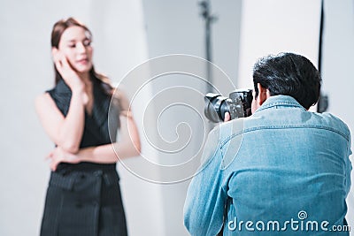 The professional photoshoot set indoor studio with Asian model actress, make up artist and photographer, behind the scene in Stock Photo