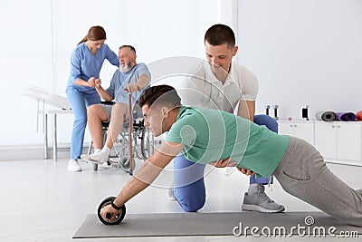 Professional physiotherapists working with patients Stock Photo