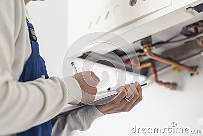 Professional plumber doing a boiler check Stock Photo