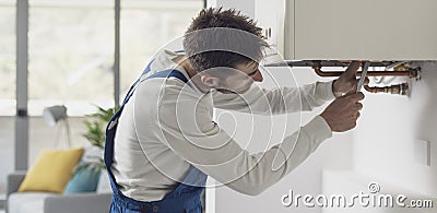 Professional plumber checking a boiler Stock Photo