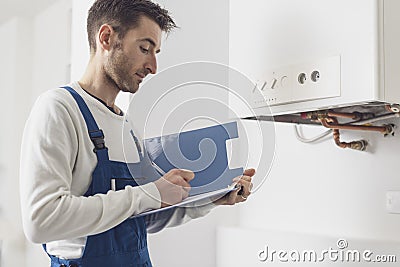 Professional plumber doing a boiler check Stock Photo